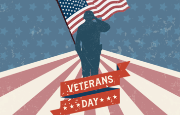 VETER SALUTING WITH AMERICAN FLAG IN BACKGROUND